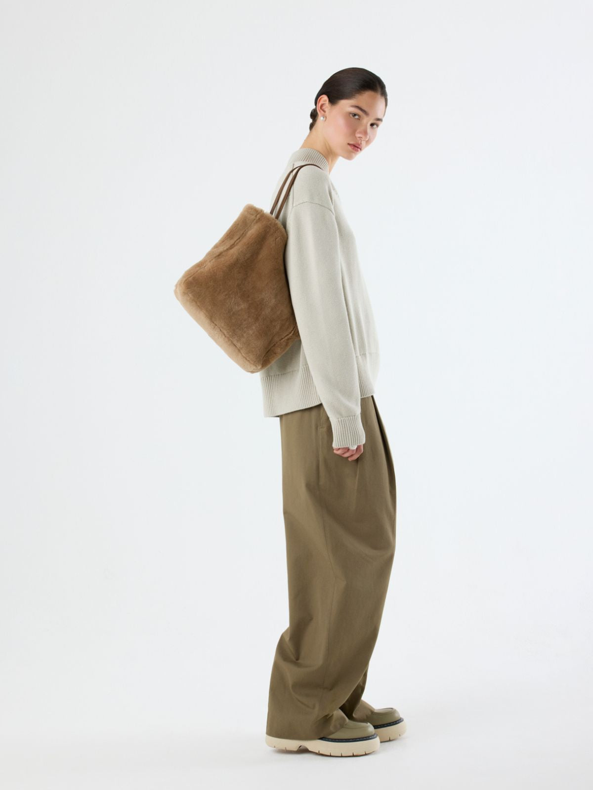 woman wearing shearling tan tote bag over shoulder by gushlow and cole