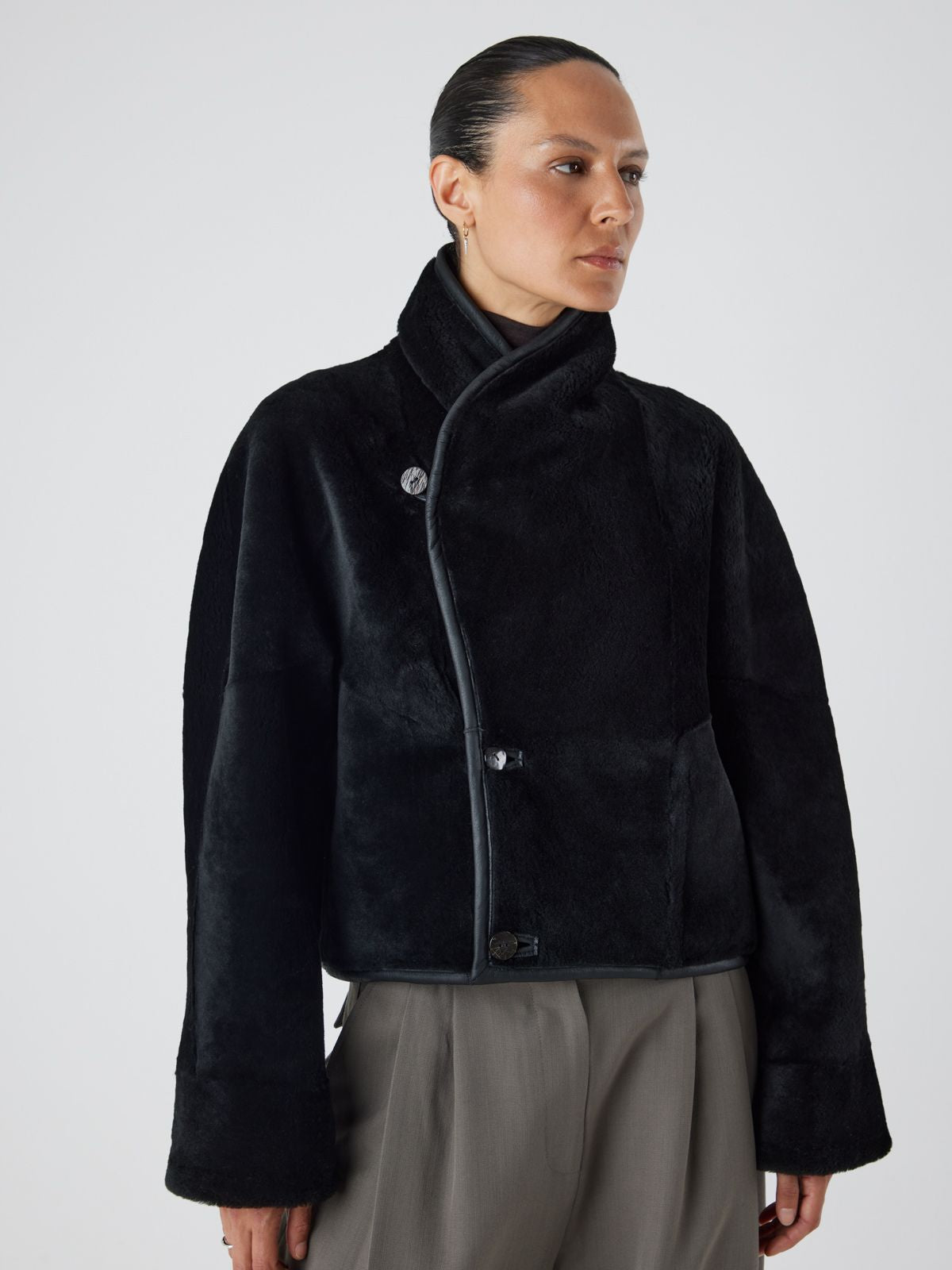 women wearing black merino shearling jacket by gushlow & Cole