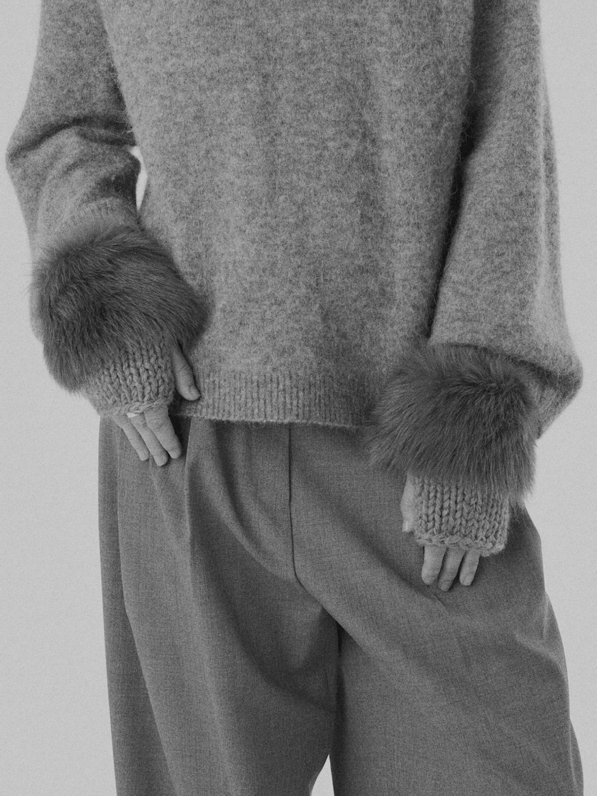 womans hands wearing gushlow & Cole grey shearling and knit mittens