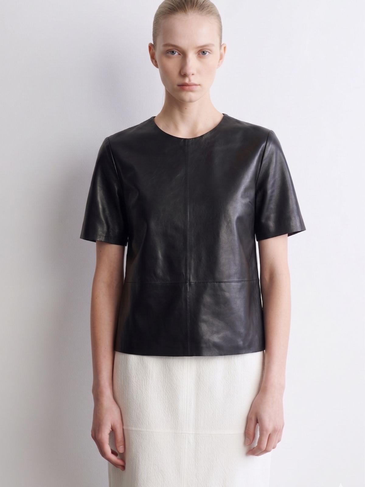 woman wearing black leather t shirt by gushlow & cole on white background