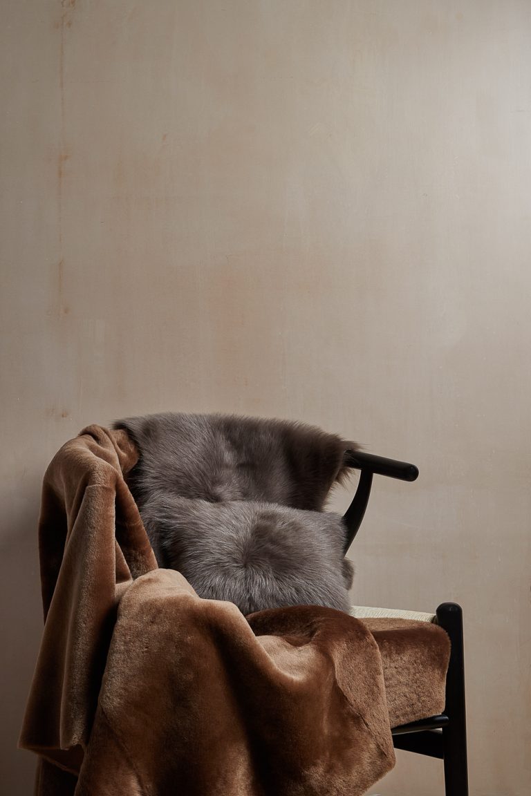 Small Toscana Sheepskin Cushion in taupe and merino throw gushlow and cole lifestyle
