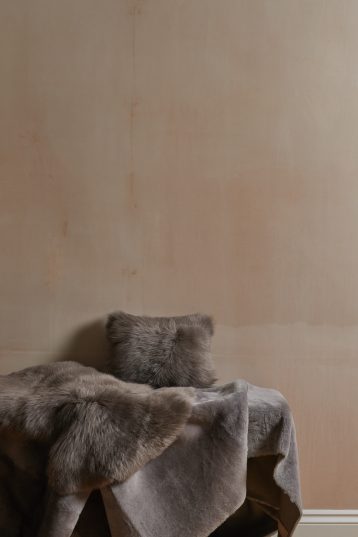 Small Toscana Sheepskin Rug in taupe with cushion gushlow and cole homeware lifestyle