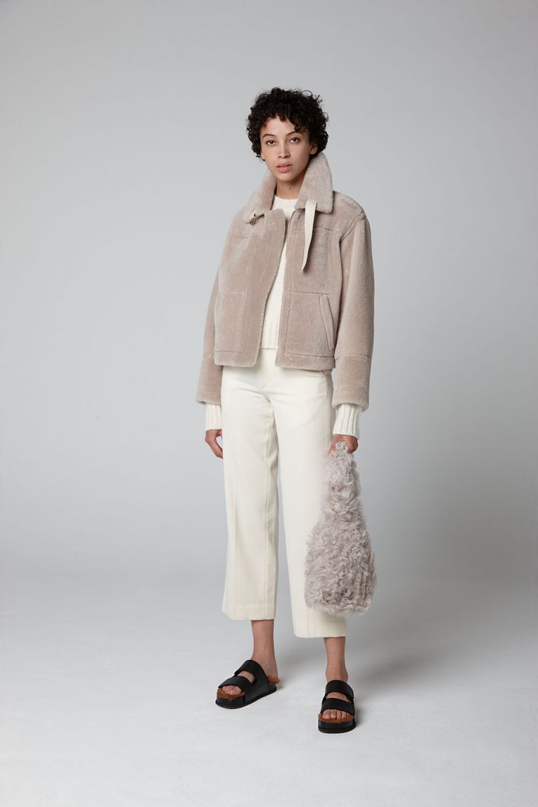 Ecru Shearling Aviator Jacket - model full length wool out with bag - women | gushlow & cole