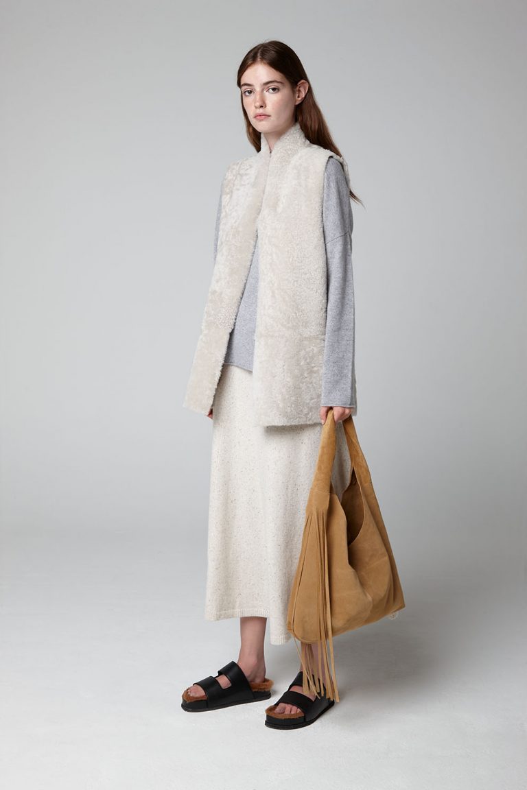 White Stand Collar Mid Shearling Gilet - model wool in full length with bag - gushlow & cole