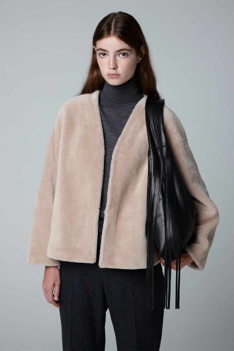 Ecru V Neck Shearling Cardigan Jacket - model crop with bag - Women | Gushlow & Cole