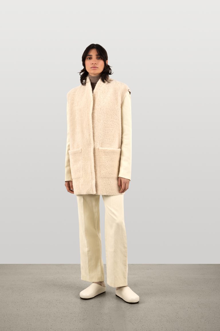 Stone White Midi Boxy Shearling Gilet | Gushlow & Cole | model full length front hand in pocket