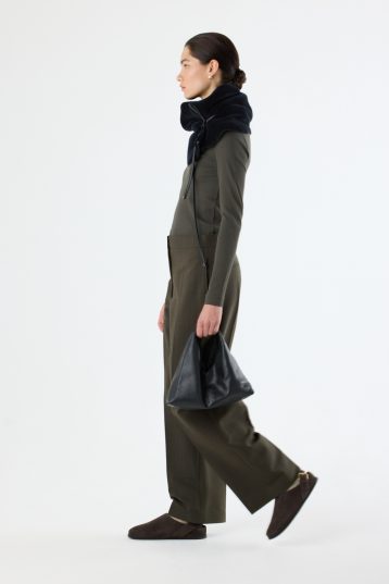 Clara Small Black Leather Shoulder Bag | Bags | Gushlow & Cole - model full length side on holding bag