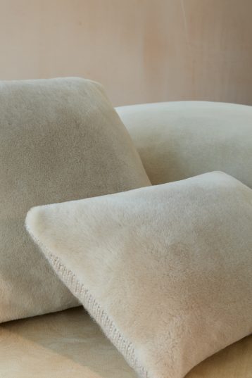Beige Shearling & Knit Lumbar Cushion | Home | Gushlow & Cole - stack of cushions on sofa