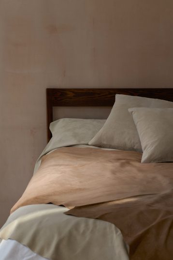 Camel Suede Throw | Home | Gushlow & Cole - lifestyle image of throw on bed with suede cushion