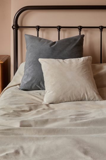 Stone White Suede Throw | Home | Gushlow & Cole - lifestyle image of throw on bed with matching suede cushion